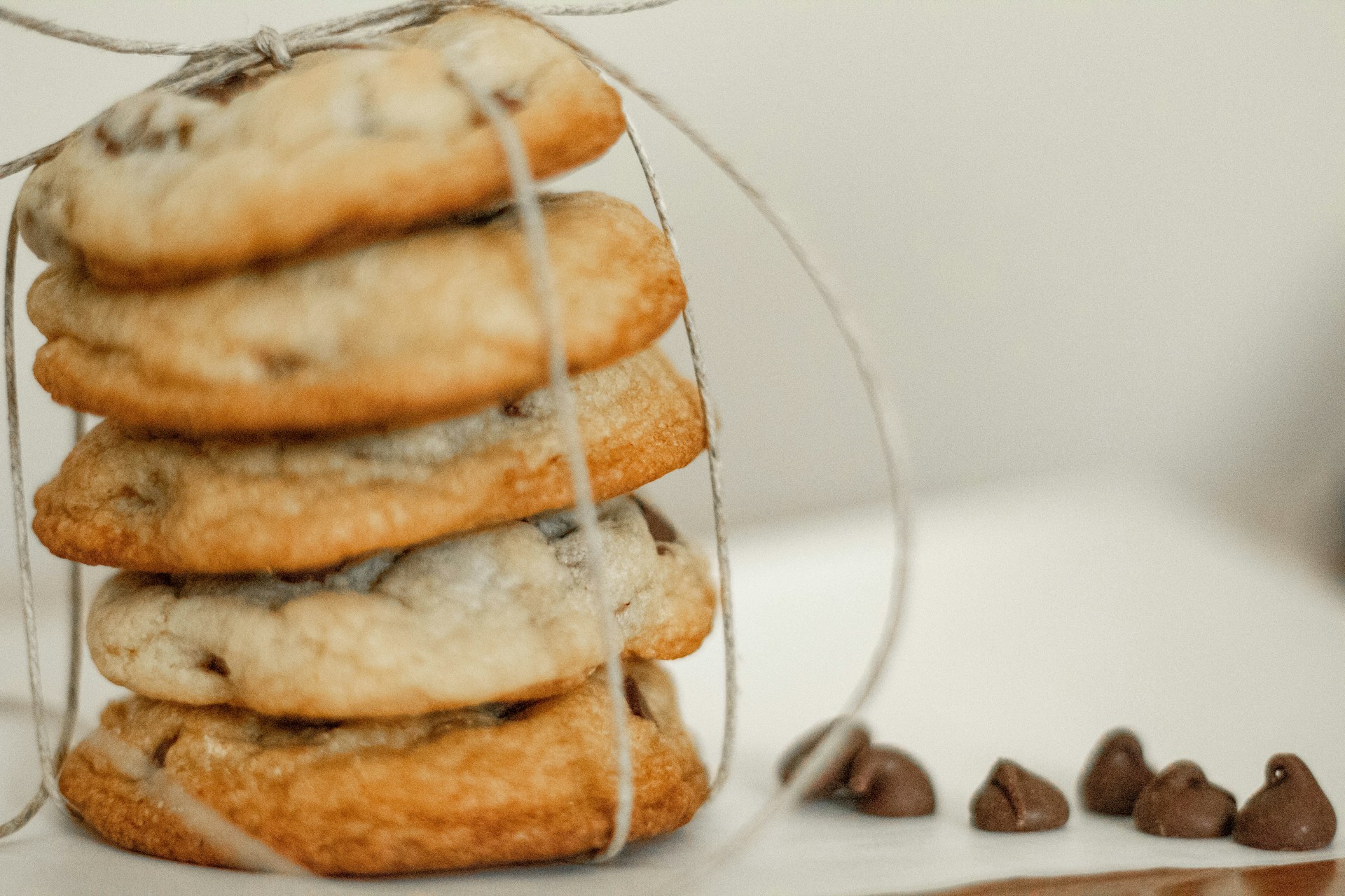 Freshly baked cookies arranged for sale with creamy chocolate chip morsels, ready to delight customers.